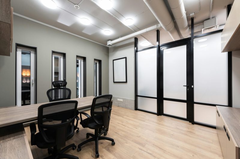 pexels-photo-7534168-7534168 Wooden table and black office chairs placed in spacious room in new contemporary workplace
